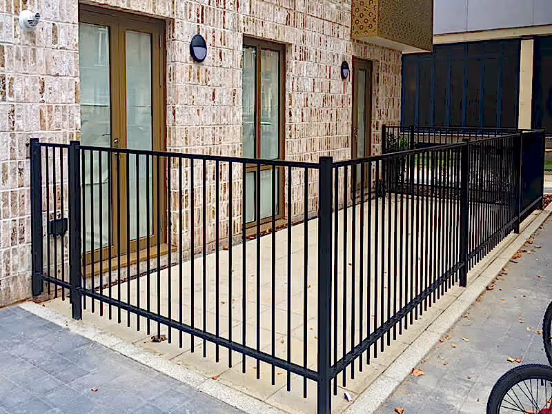 Flat top metal railings around housing
