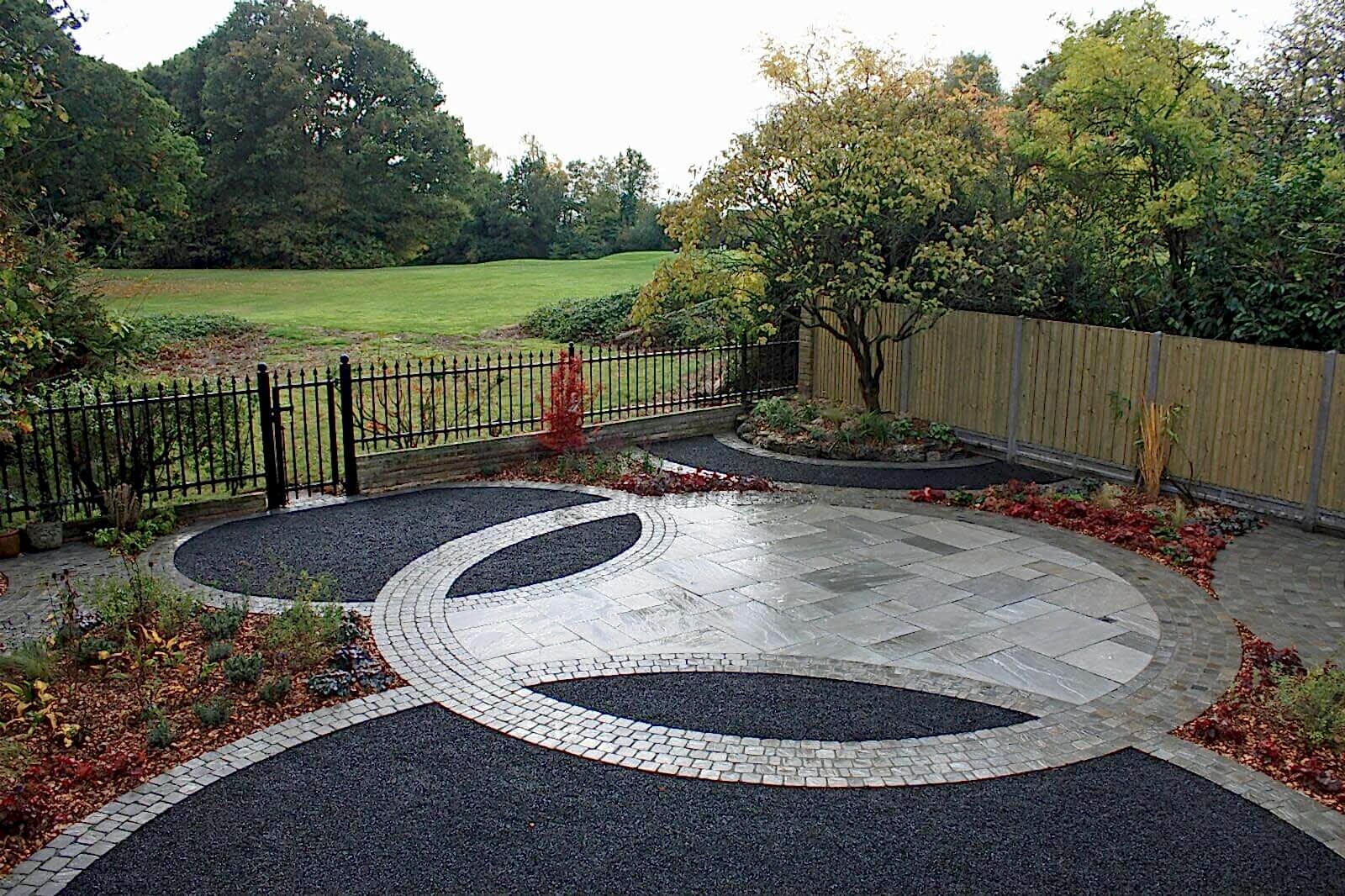 front garden view of basalt paving and fencing