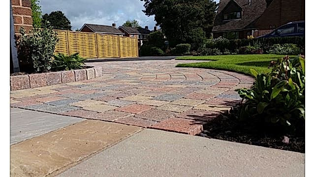 A drive with style paving and fence