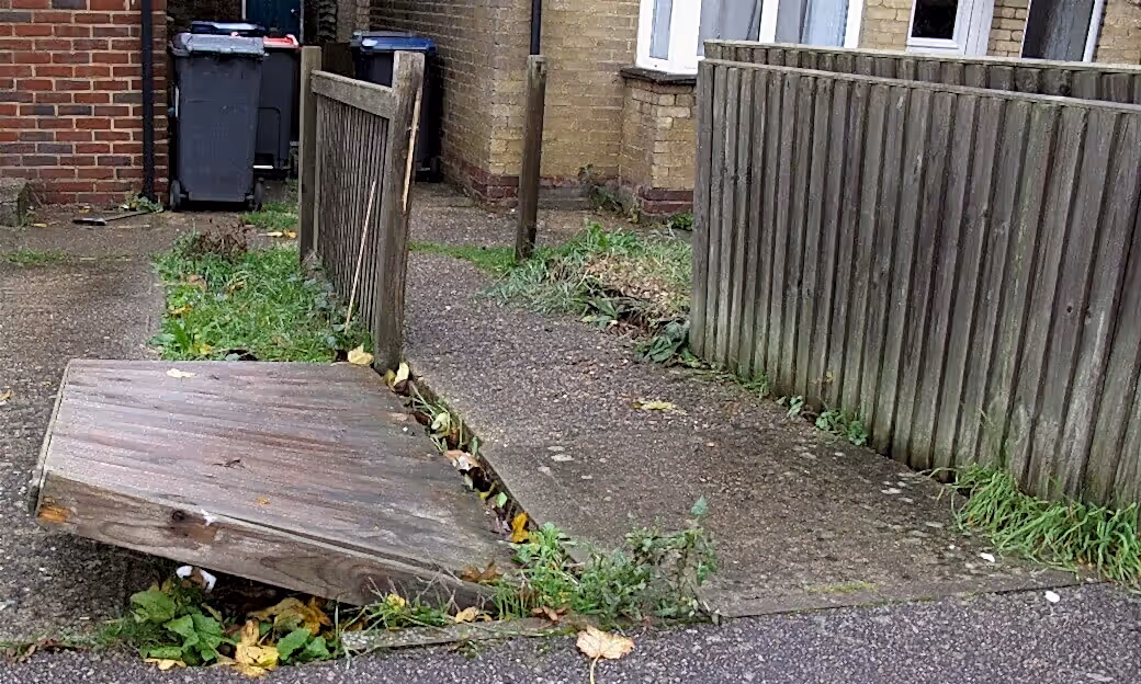 Storm damaged broken closeboard fence